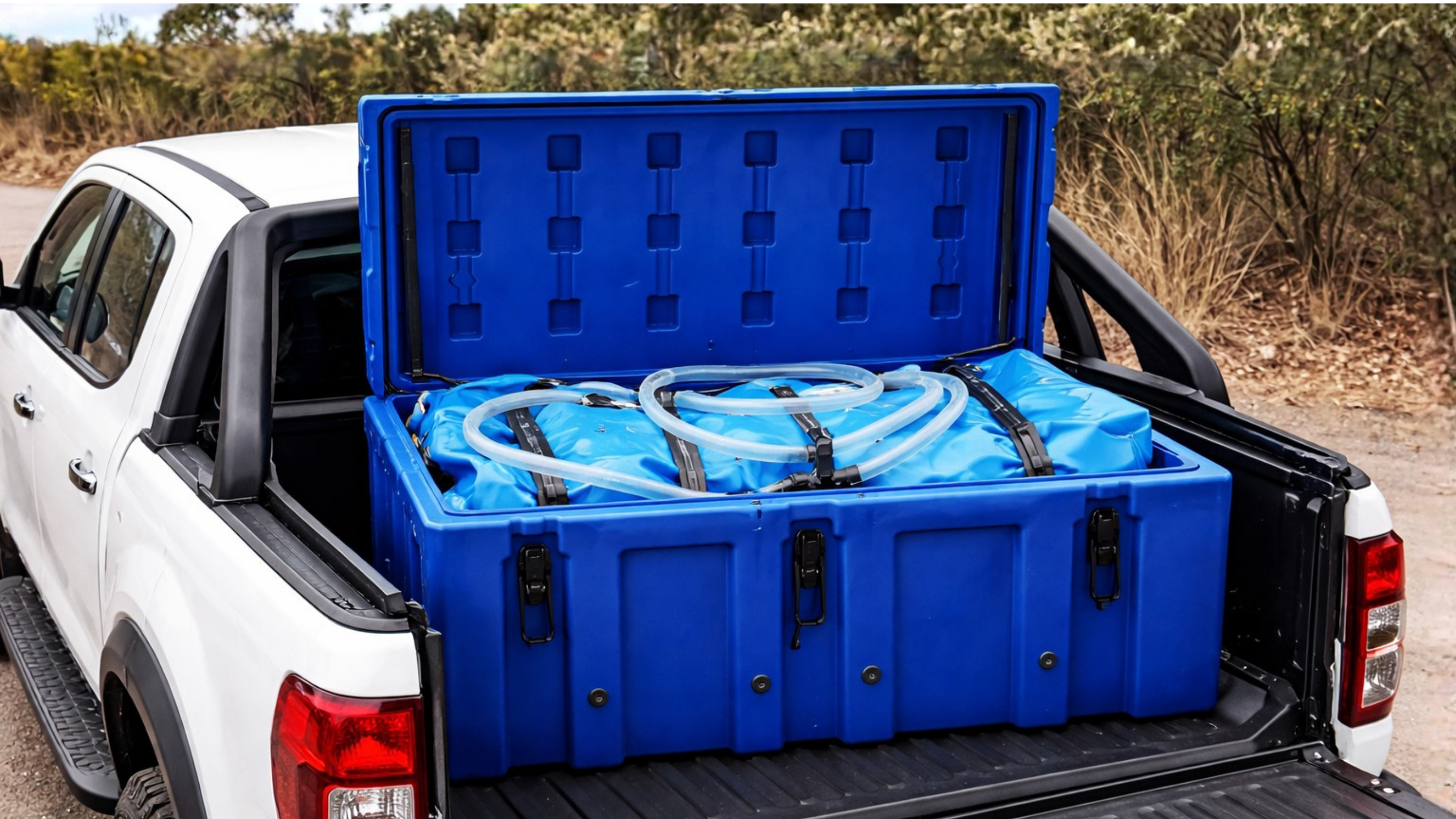 Flexible Fuel Bladder in storage box placed on the tray of a 4x4 cargo area, showing realistic positioning and secure transport