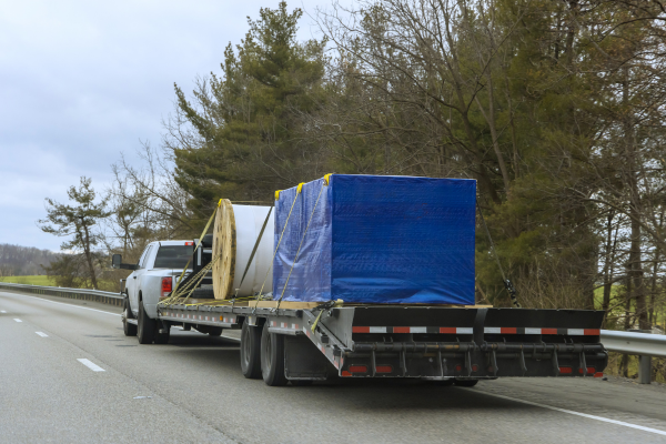 320GSM extra heavy-duty waterproof PE tarp covering goods on trailer – UV stabilised tarpaulin for transport protection Australia