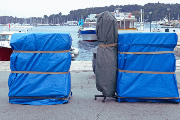 UV-stabilised tarp covering goods on trailer for outdoor transport