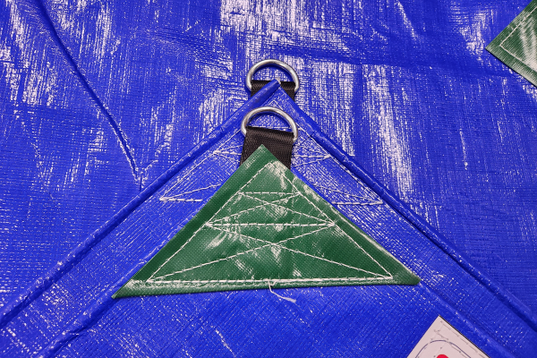 PE 320GSM heavy-duty tarp folded showing reinforced D-ring corner