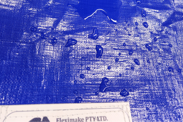 Industrial PE tarp with water droplets demonstrating waterproof coating