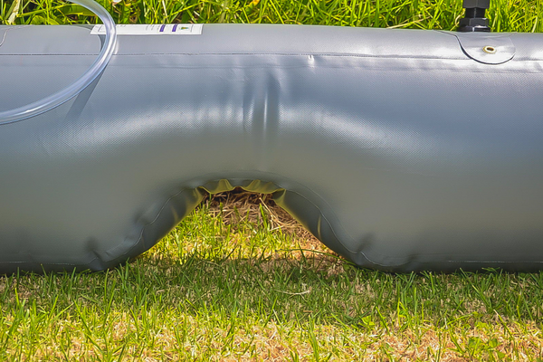 Close-up of the DWN125BH-Standard transmission hump cutout design, showing the tapered recess that allows the tank to sit flush over the center tunnel.